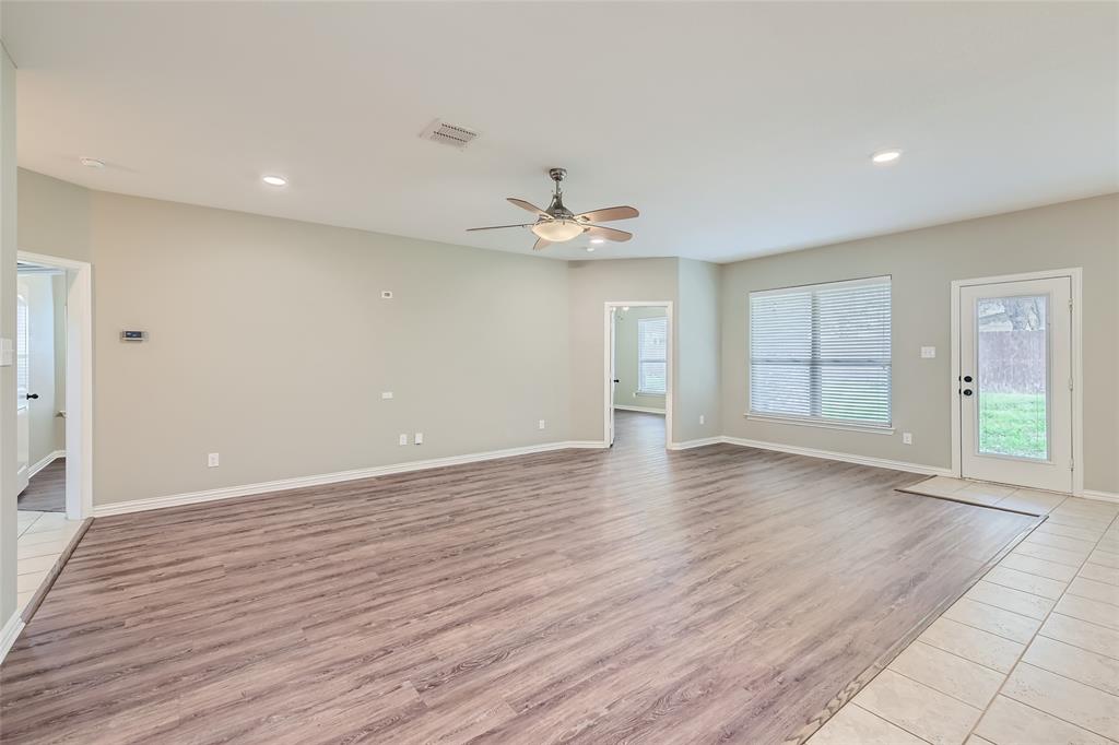 204 West Patton Street Alvarado, TX 76009 - Photo 5 of 17 a view of an empty room with wooden floor and a window