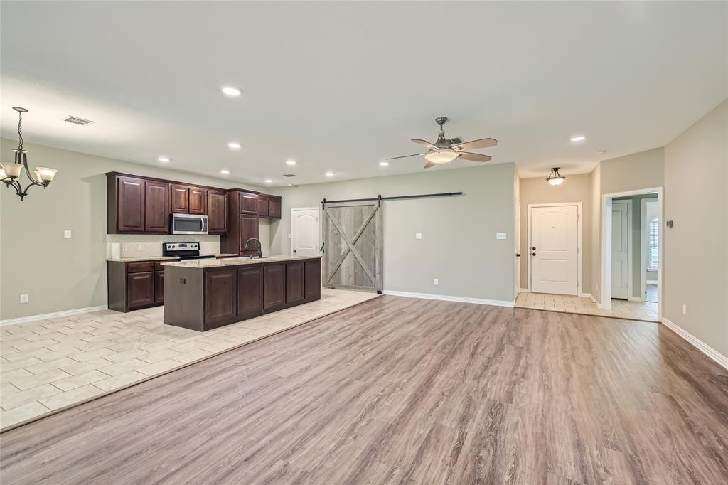 204 West Patton Street Alvarado, TX 76009 - Photo 17 of 17 a large kitchen with stainless steel appliances kitchen island a large counter top a sink and cabinets