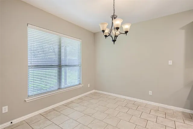 a large kitchen with stainless steel appliances kitchen island a large counter top a sink and cabinets