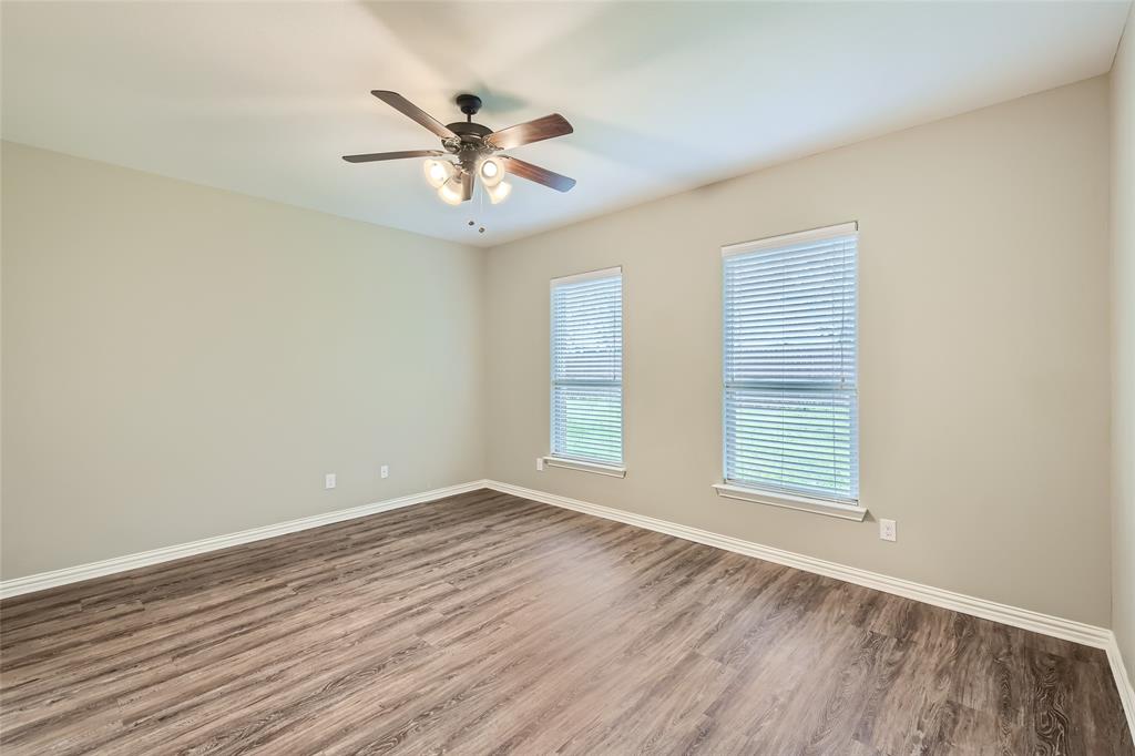 204 West Patton Street Alvarado, TX 76009 - Photo 8 of 17 a view of an empty room with wooden floor and a window