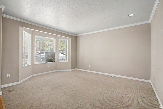 2058 California Avenue, Unit 2 Provo, UT 84606 - Photo 5 of 32 Spacious room featuring a bay window, neutral carpeting, recessed lighting, and crown molding