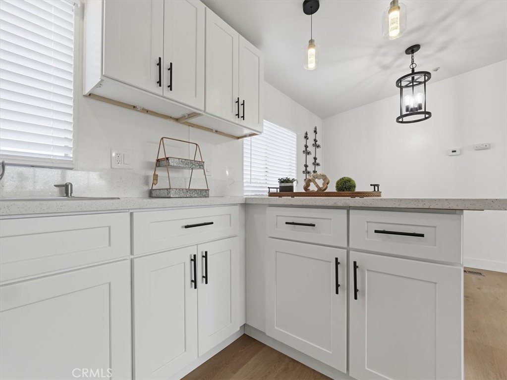 11878 Pacific Road Phelan, CA 92371 - Photo 11 of 50 a kitchen with cabinets appliances and a sink