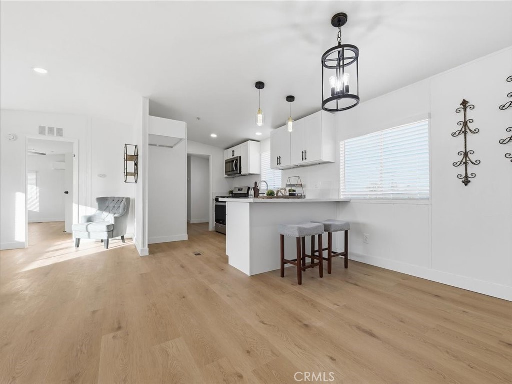 11878 Pacific Road Phelan, CA 92371 - Photo 14 of 50 a kitchen with stainless steel appliances kitchen island hardwood floor and a sink