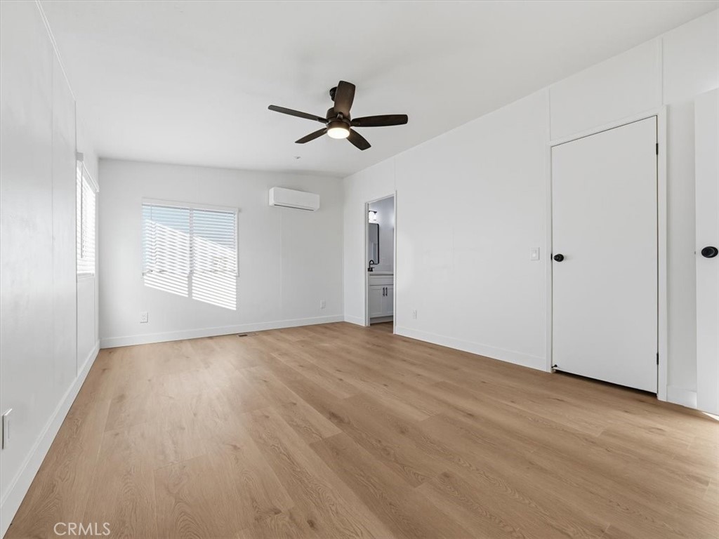 11878 Pacific Road Phelan, CA 92371 - Photo 18 of 50 a view of empty room with wooden floor and fan