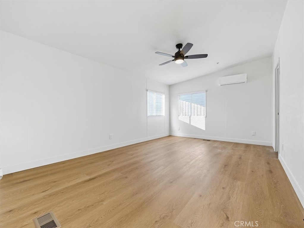 11878 Pacific Road Phelan, CA 92371 - Photo 22 of 50 wooden floor in an empty room with a window