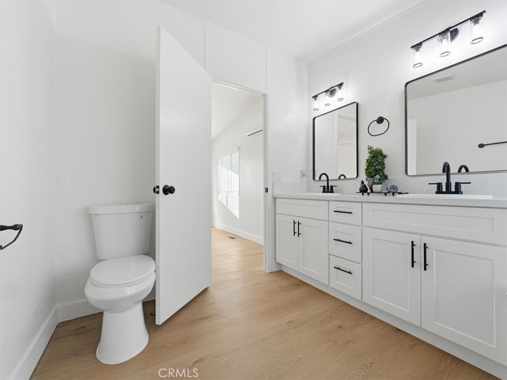 11878 Pacific Road Phelan, CA 92371 - Photo 23 of 50 a bathroom with a double vanity sink toilet and a mirror