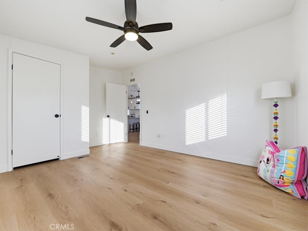 11878 Pacific Road Phelan, CA 92371 - Photo 27 of 50 a view of an empty room with a window and wooden floor