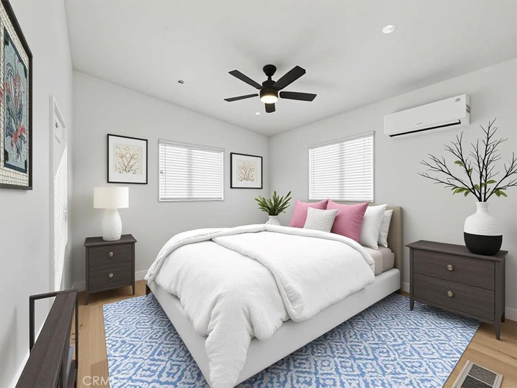 11878 Pacific Road Phelan, CA 92371 - Photo 29 of 50 a bedroom with a bed and a potted plant