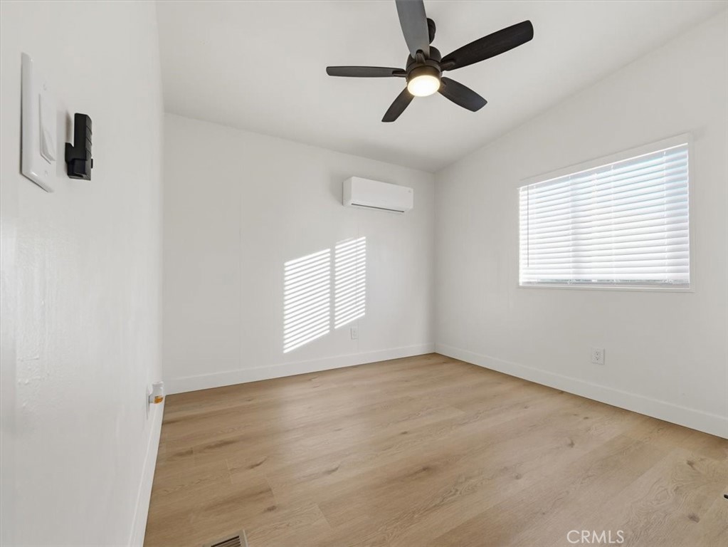 11878 Pacific Road Phelan, CA 92371 - Photo 32 of 50 wooden floor in an empty room with a window