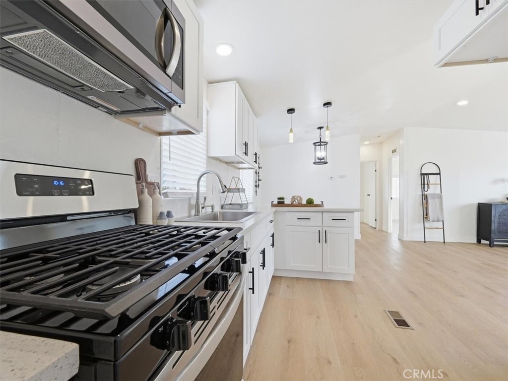 11878 Pacific Road Phelan, CA 92371 - Photo 10 of 50 a kitchen with stove and cabinets
