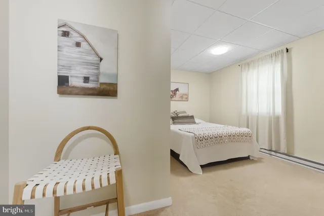 a bedroom with a bed and a painting on the wall