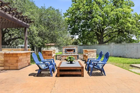 a view of a patio with table and chairs potted plants with wooden fence