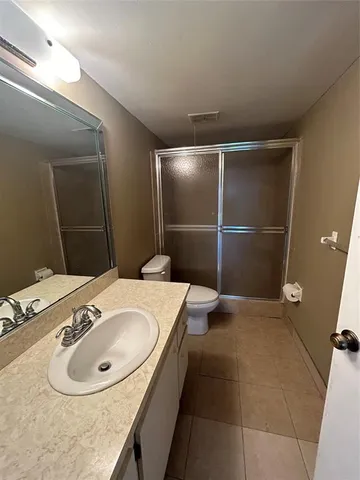 a bathroom with a sink toilet and a mirror