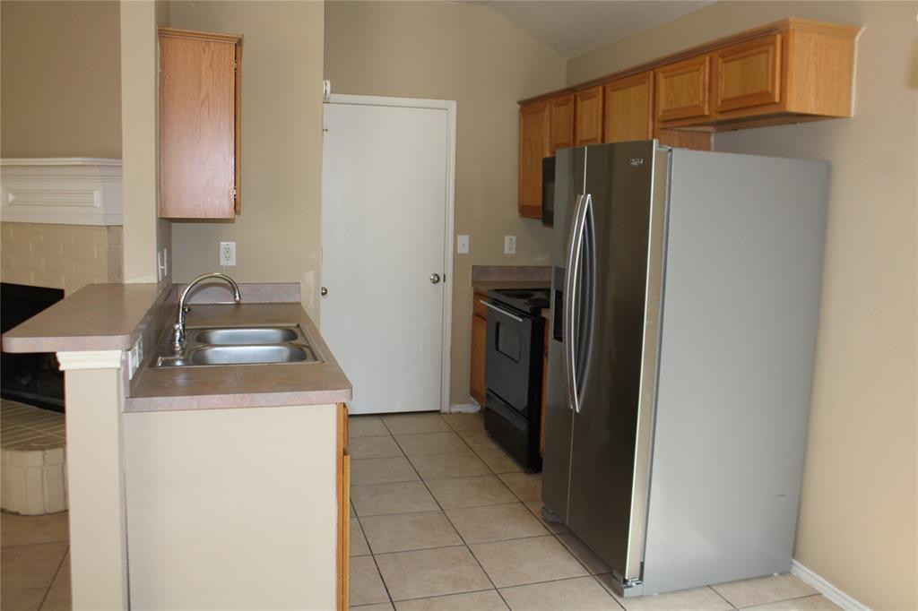 2136 Coelum Court Dallas, TX 75253 - Photo 18 of 29 a kitchen with a refrigerator sink and stove