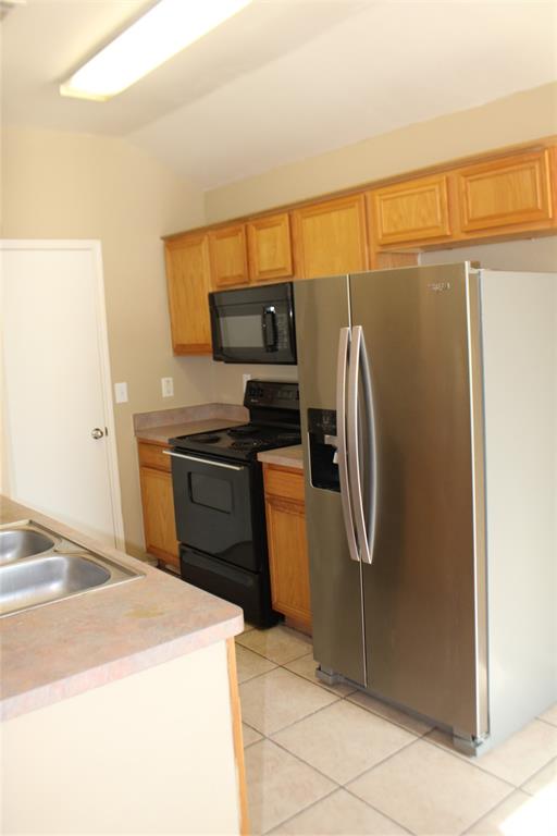 2136 Coelum Court Dallas, TX 75253 - Photo 20 of 29 a kitchen with a refrigerator and a stove