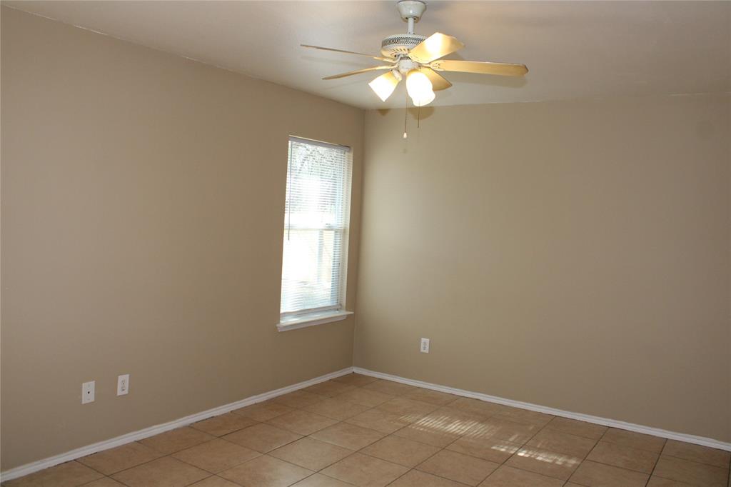 2136 Coelum Court Dallas, TX 75253 - Photo 4 of 29 an empty room with windows and fan