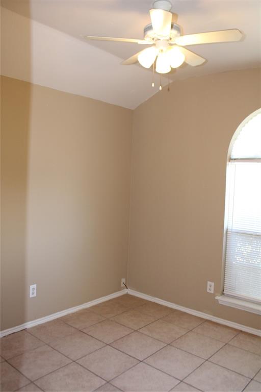 2136 Coelum Court Dallas, TX 75253 - Photo 10 of 29 an empty room with a window and a fan