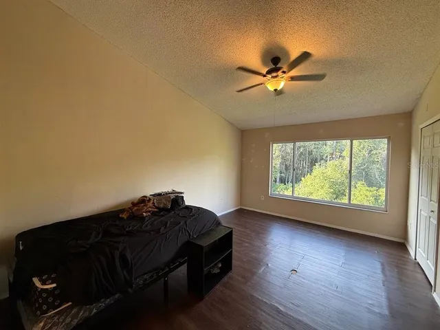 a living room with furniture and a ceiling fan