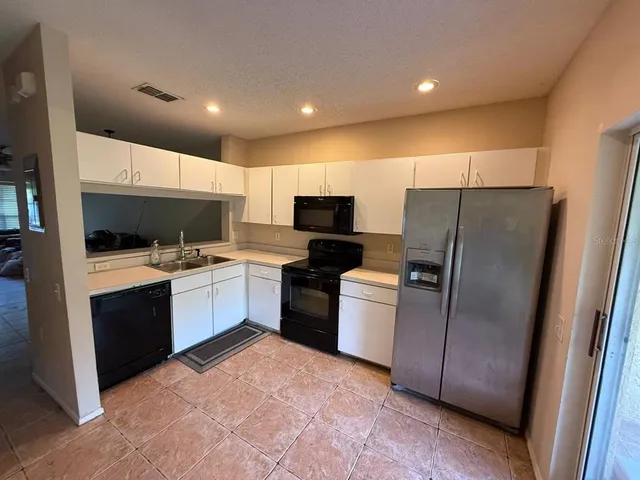 a kitchen with a refrigerator sink and microwave