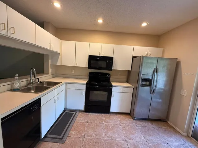 a kitchen with a sink and stainless steel appliances