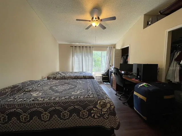 a bedroom with a bed dresser and a window