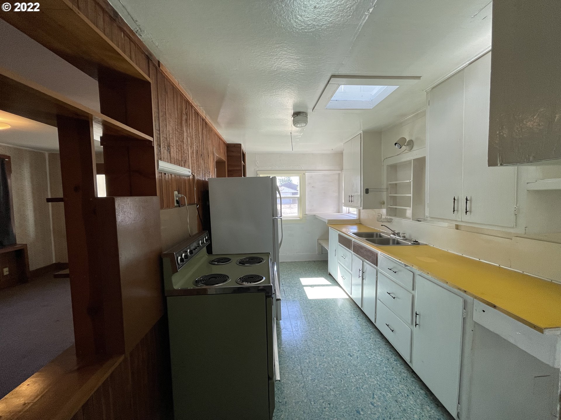 443 South 34th Street Springfield, OR 97478 - Photo 8 of 13 a large kitchen with stainless steel appliances kitchen island granite countertop a refrigerator a stove and a sink