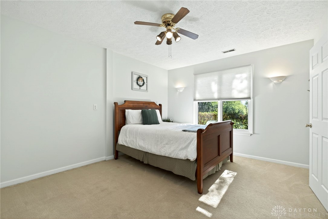 330 South Alpha Bellbrook Road Bellbrook, OH 45305 - Photo 49 of 87 This tranquil bedroom offers comfort with soft flooring and a large window providing verdant views.