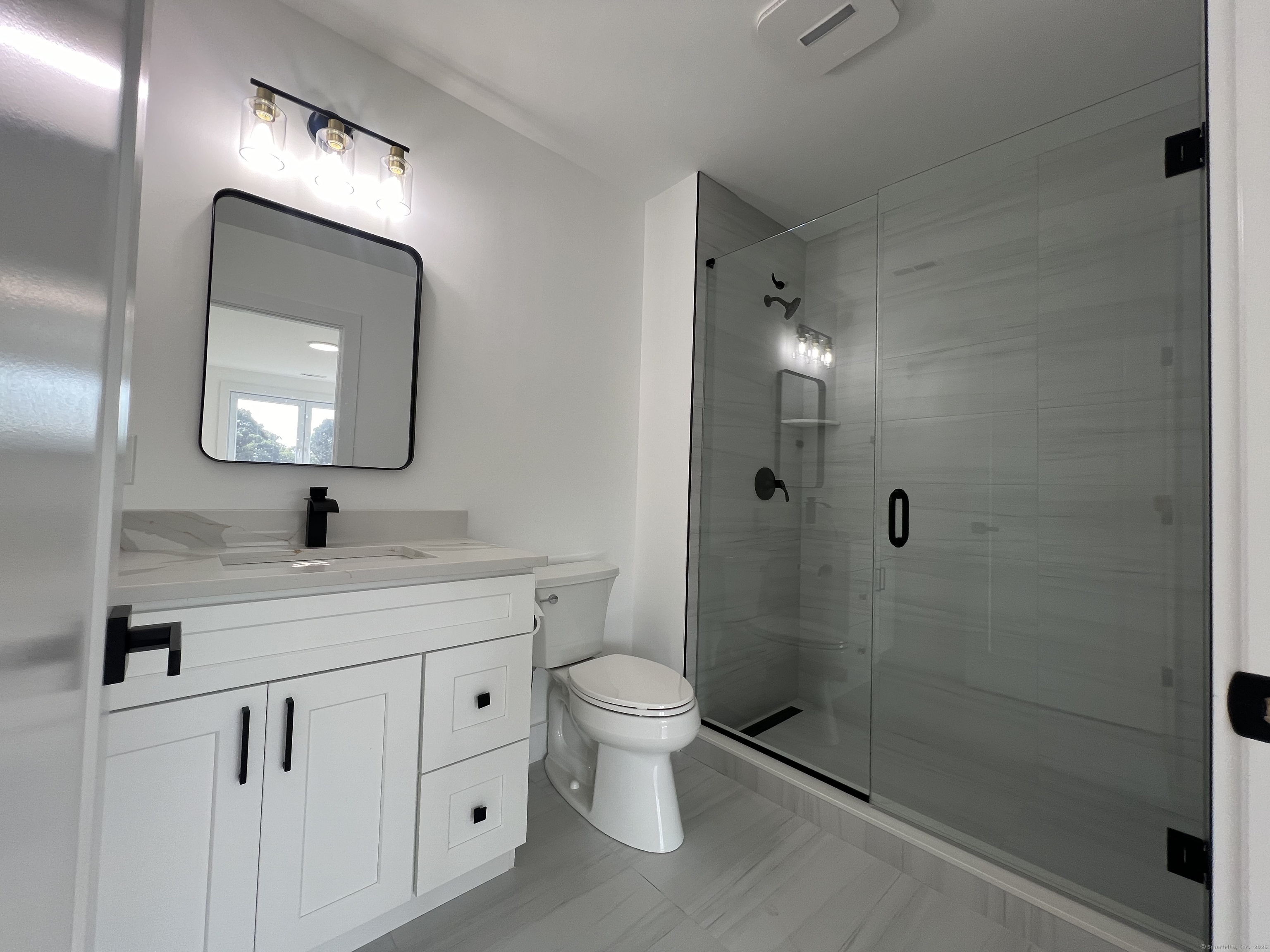 211 Ferry Boulevard, Unit 203 Stratford, CT 06615 - Photo 11 of 16 a bathroom with a toilet sink and shower