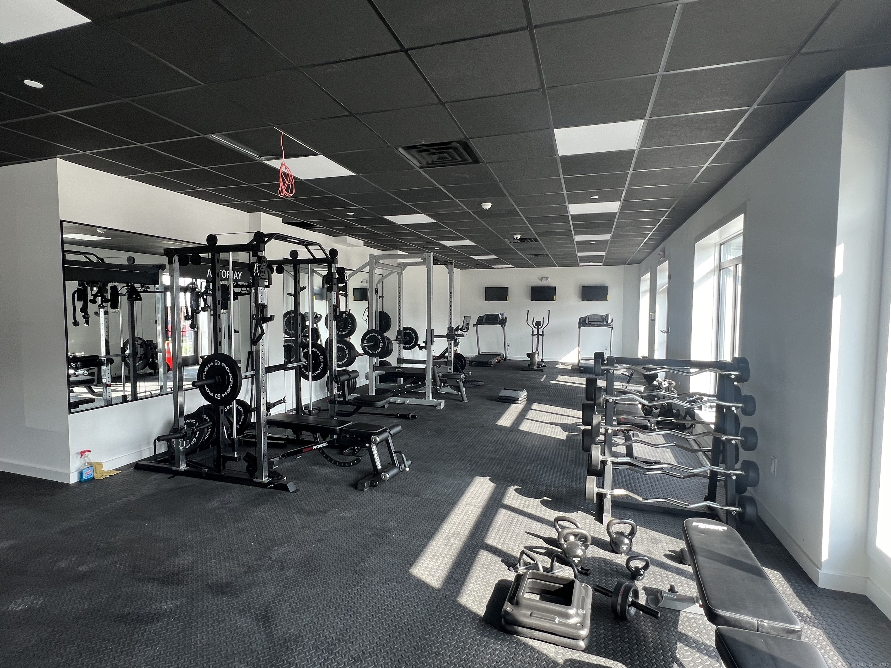 211 Ferry Boulevard, Unit 203 Stratford, CT 06615 - Photo 14 of 16 a room with gym equipment and a view of living room