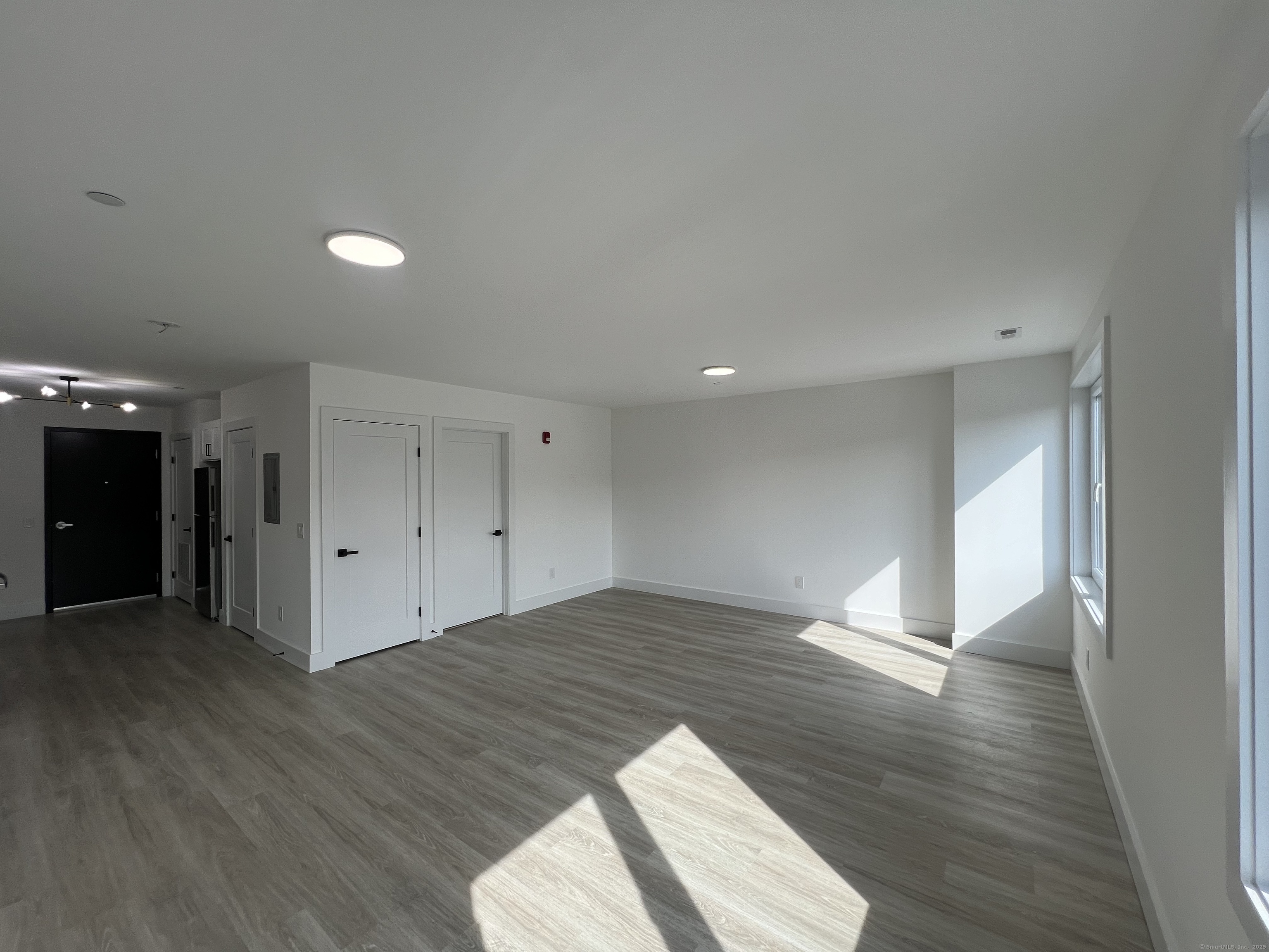 211 Ferry Boulevard, Unit 203 Stratford, CT 06615 - Photo 6 of 16 a view of an empty room and wooden floor