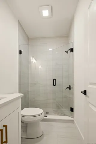 a bathroom with a toilet sink and shower