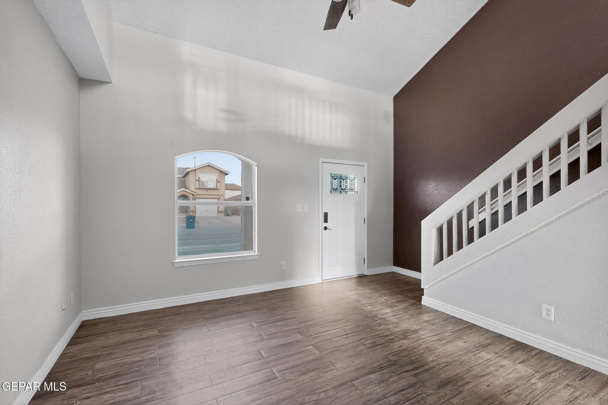 3626 Dominican Street El Paso, TX 79936 - Photo 3 of 20 a view of an empty room with wooden floor and a window