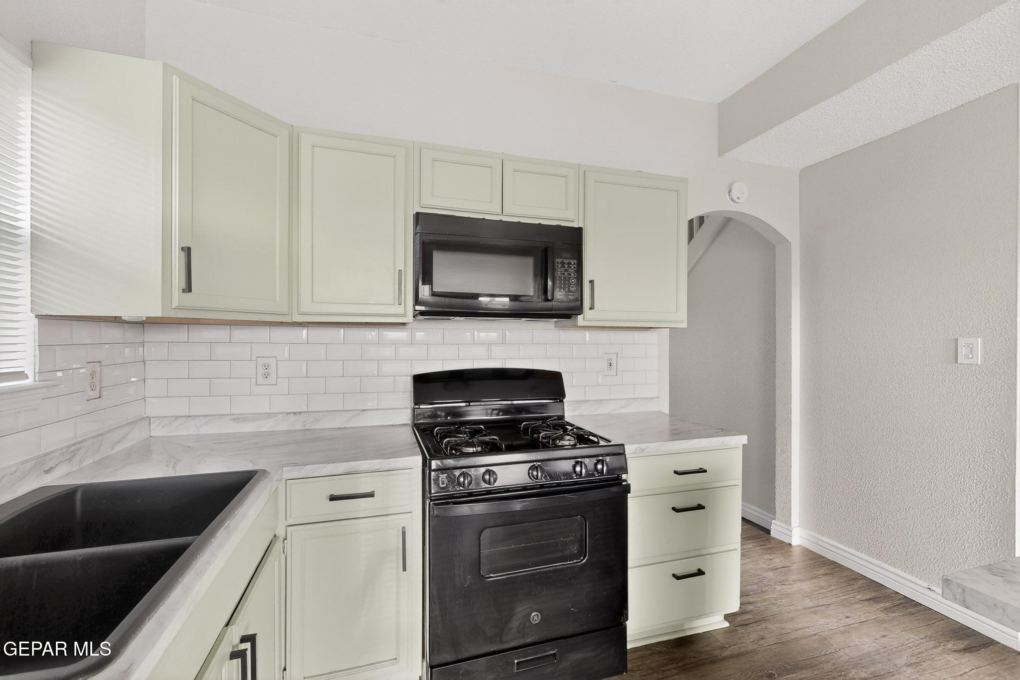 3626 Dominican Street El Paso, TX 79936 - Photo 6 of 20 a kitchen with cabinets stainless steel appliances and a sink