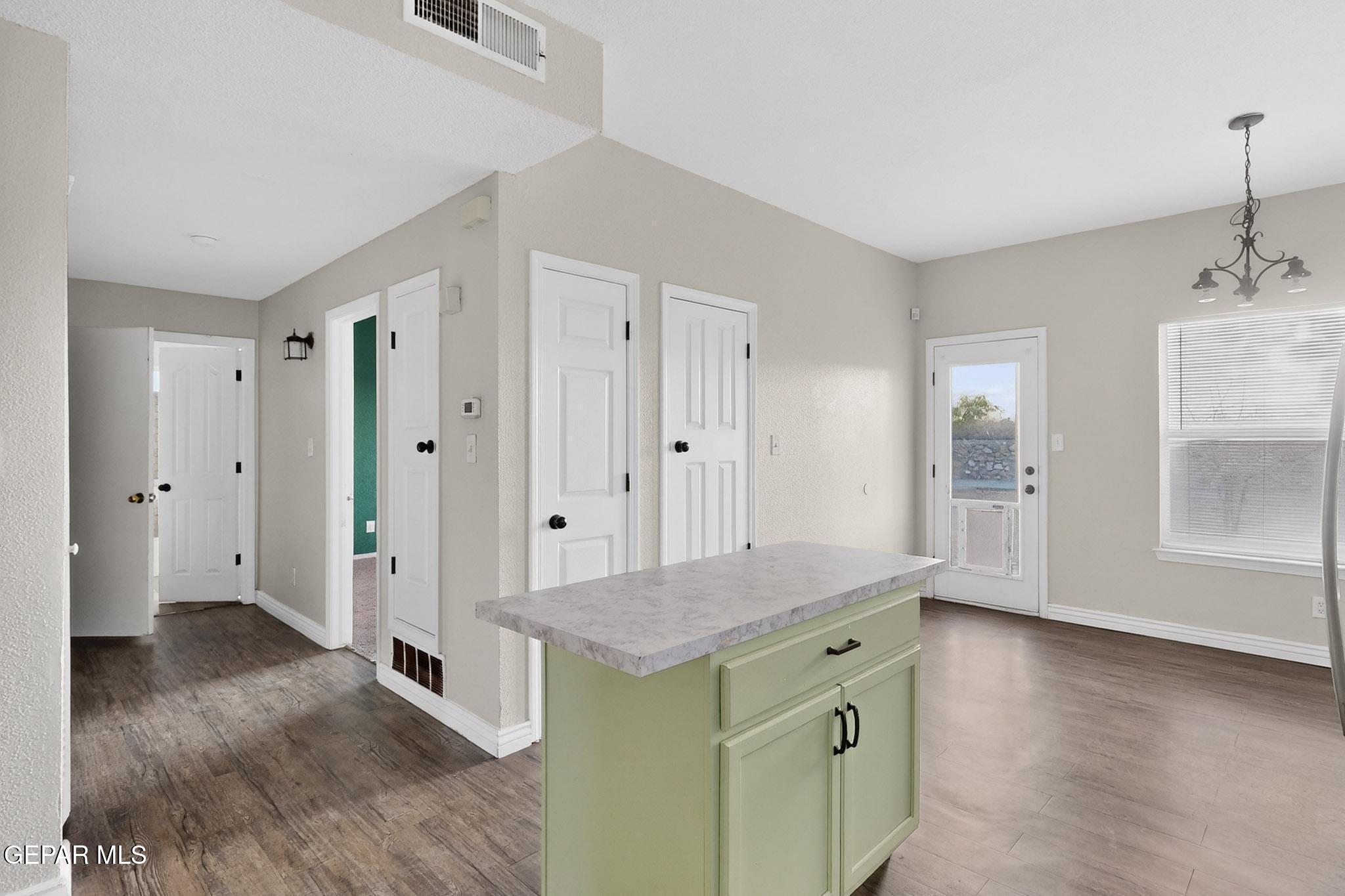 3626 Dominican Street El Paso, TX 79936 - Photo 7 of 20 wooden floor with white cabinets and wooden floor