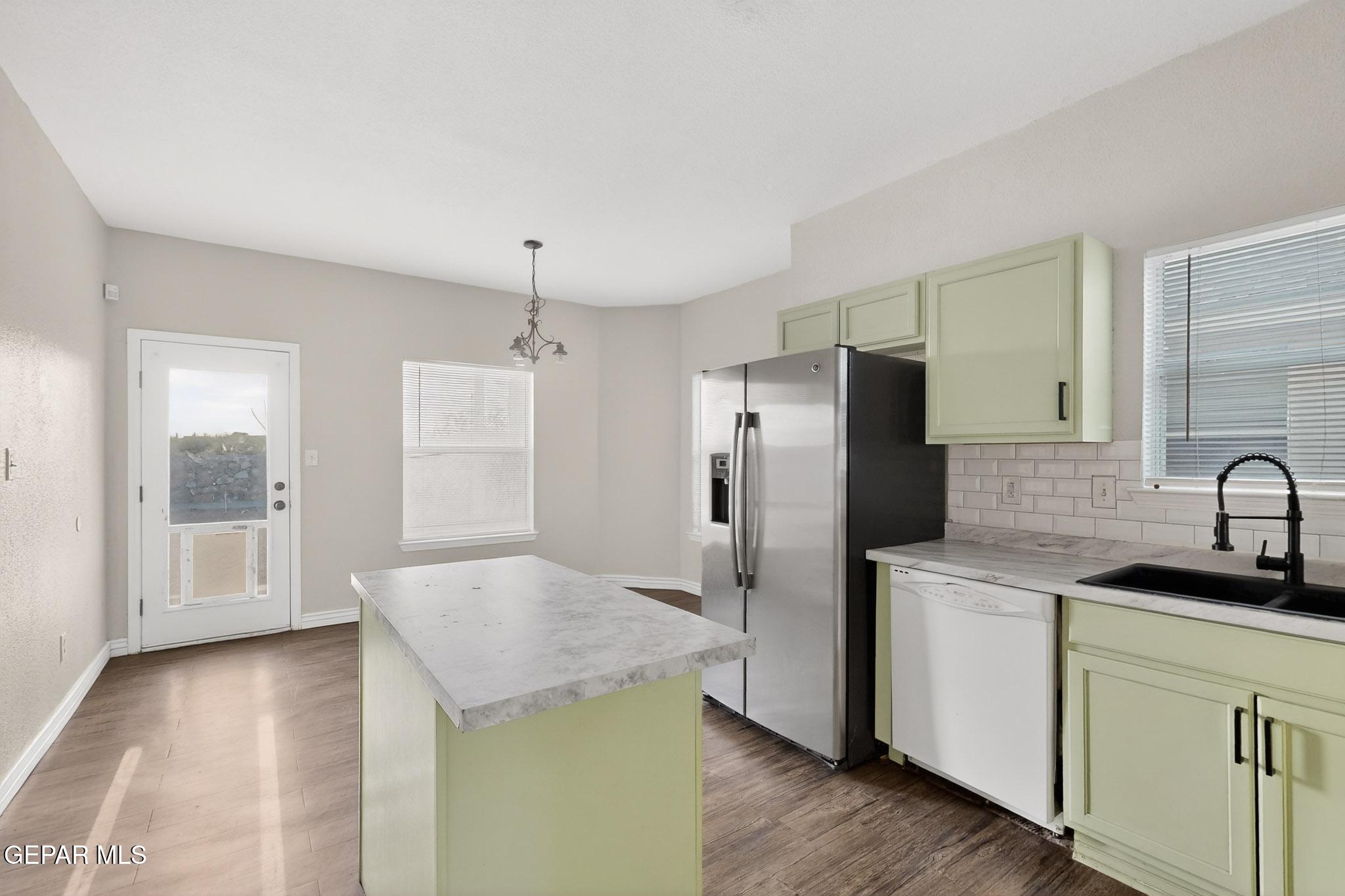 3626 Dominican Street El Paso, TX 79936 - Photo 8 of 20 a kitchen with a refrigerator sink and cabinets