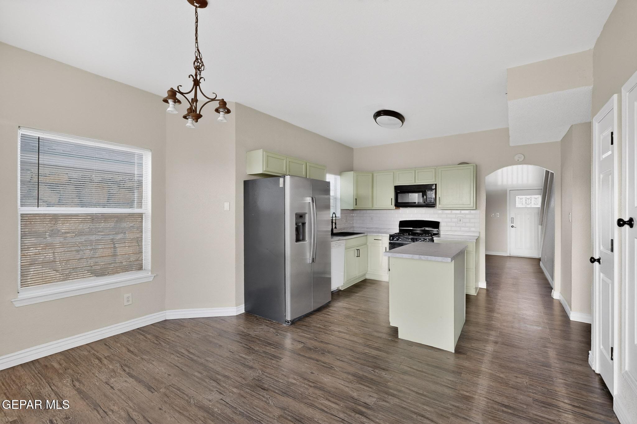 3626 Dominican Street El Paso, TX 79936 - Photo 9 of 20 a view of a kitchen with refrigerator and wooden floor