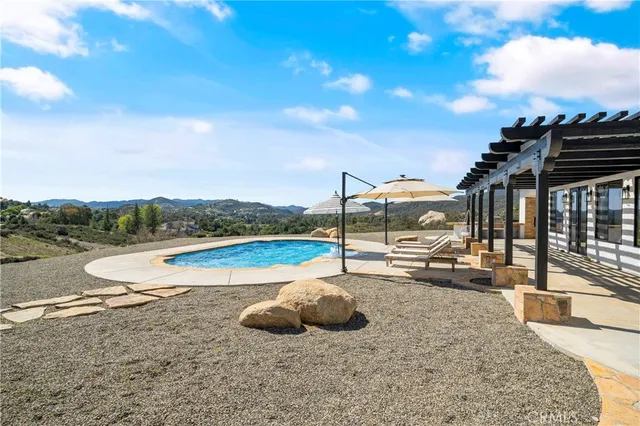 a view of a swimming pool with a lounge chair