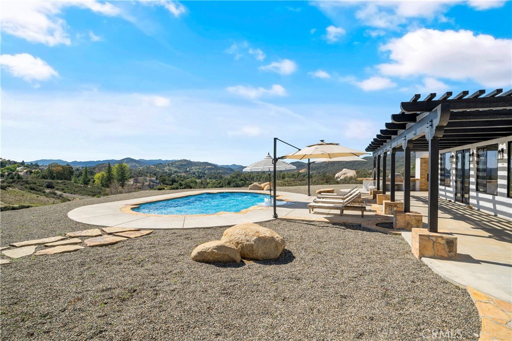 37700 Calle De Lobo Murrieta, CA 92562 - Photo 5 of 7 a view of a swimming pool with a lounge chair