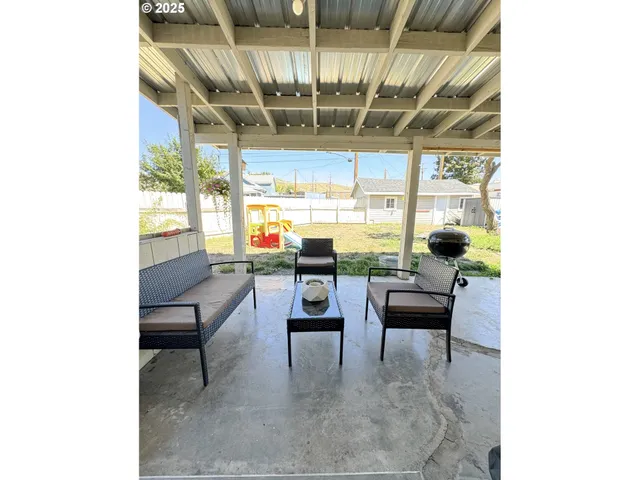 a dining room with furniture and a chandelier