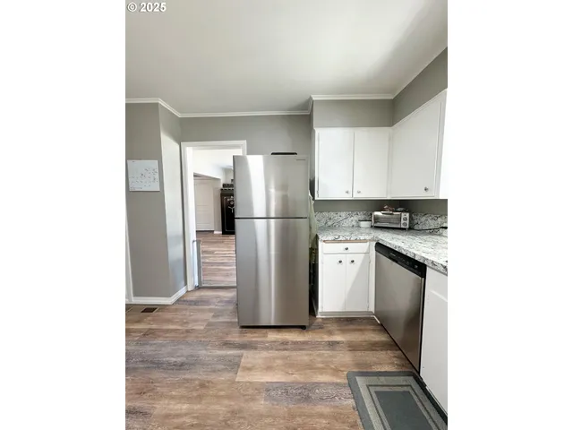 a kitchen with a refrigerator and a stove