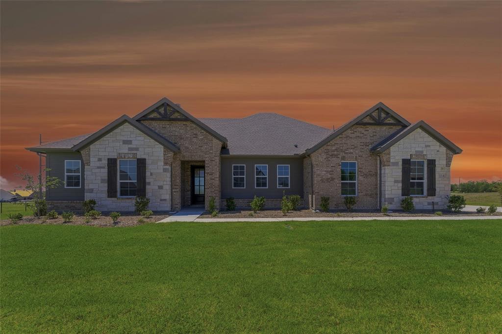 Stone and brick exterior with dark wood shutters