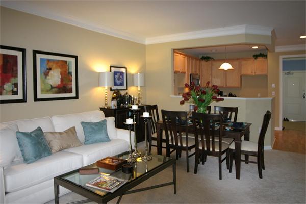 75 Augustus Court, Unit 102 Reading, MA 01867 - Photo 1 of 1 a view of a dining room and livingroom with furniture a rug and a painting