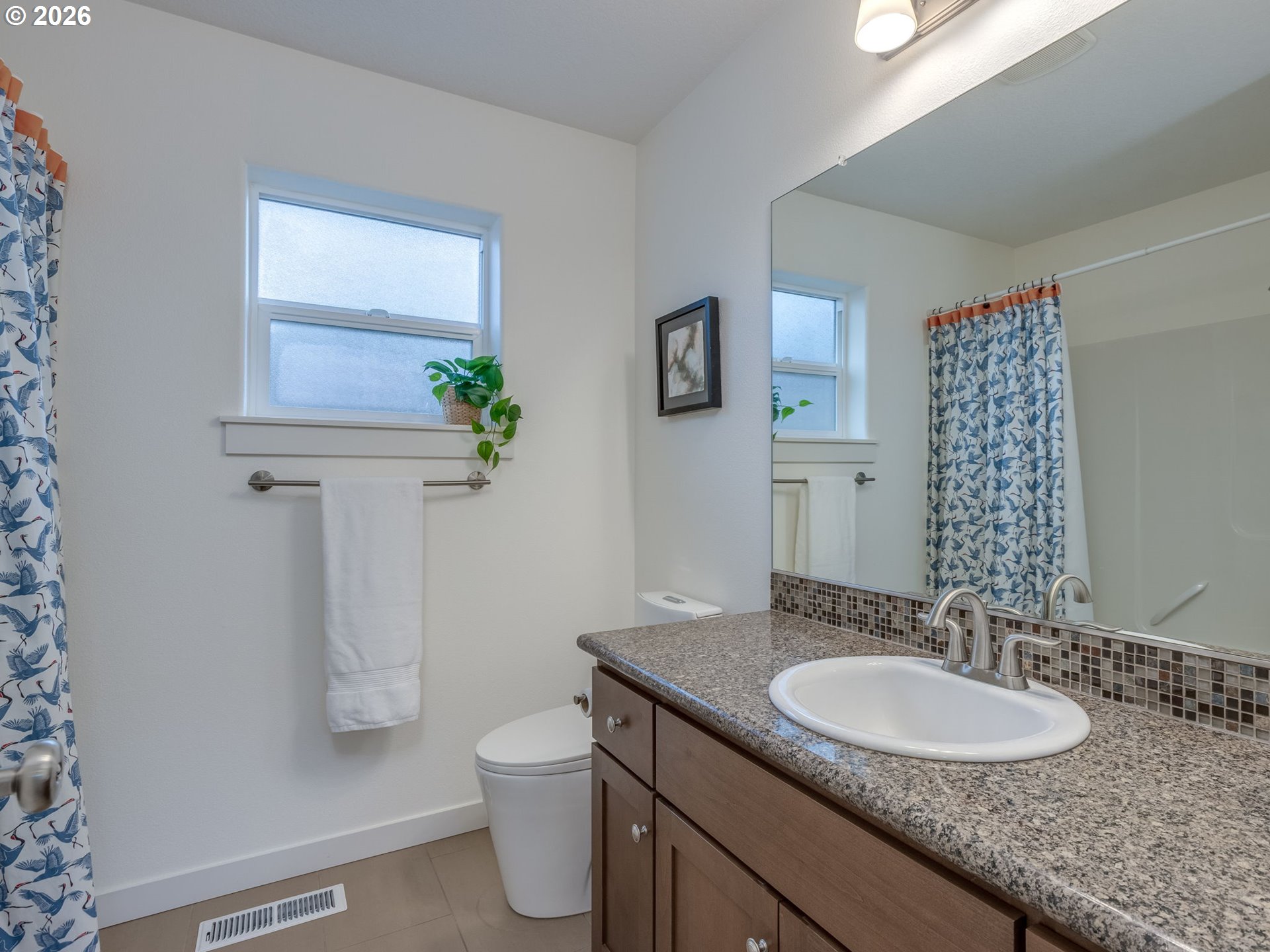 5619 Southeast Carlton Street Portland, OR 97206 - Photo 14 of 30 a bathroom with a granite countertop sink toilet and mirror
