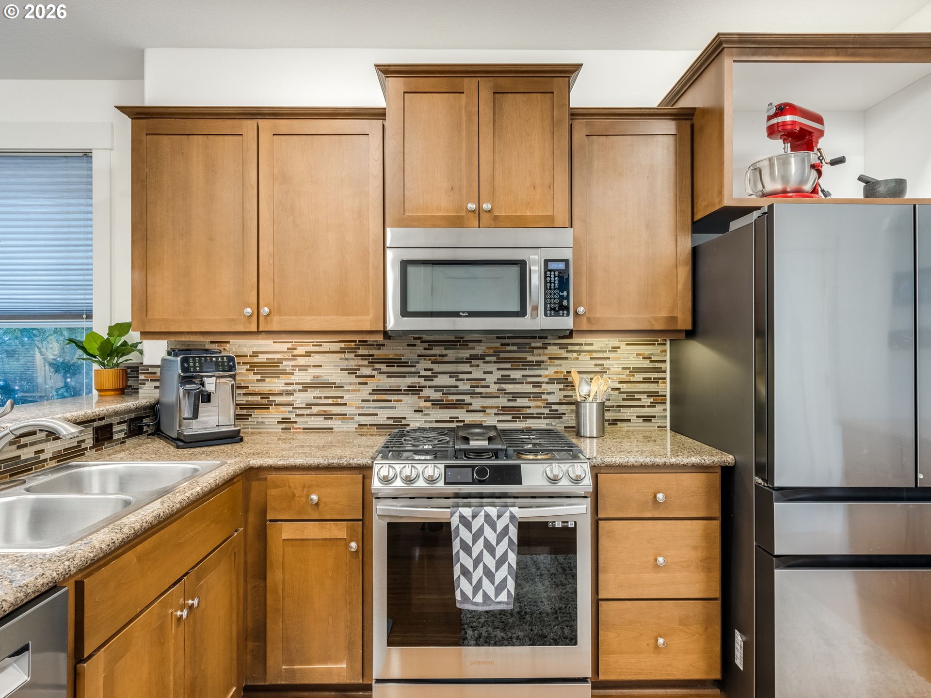 5619 Southeast Carlton Street Portland, OR 97206 - Photo 6 of 30 a kitchen with a sink stove and refrigerator