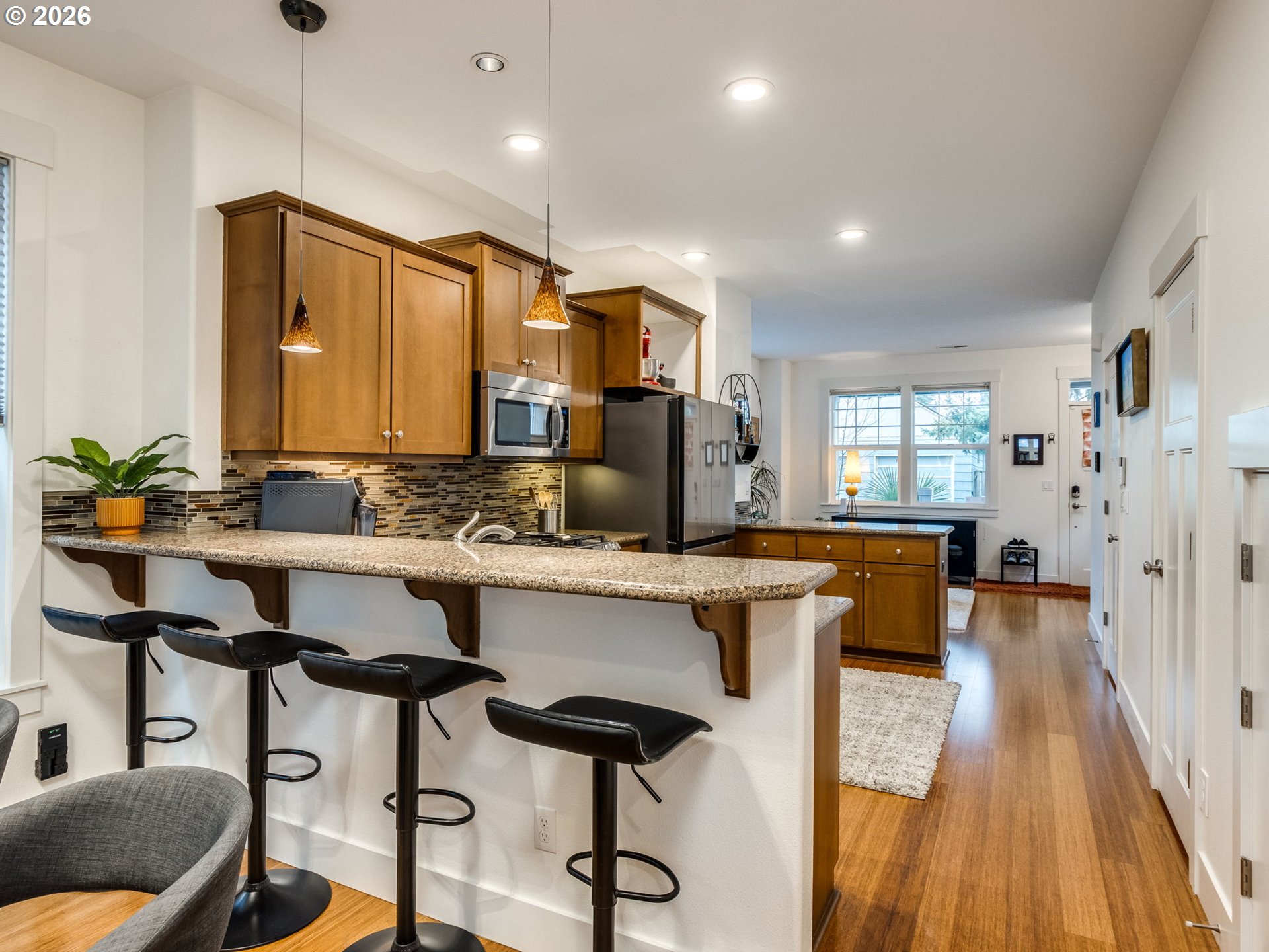 5619 Southeast Carlton Street Portland, OR 97206 - Photo 7 of 30 a kitchen with stainless steel appliances granite countertop sink stove and cabinets