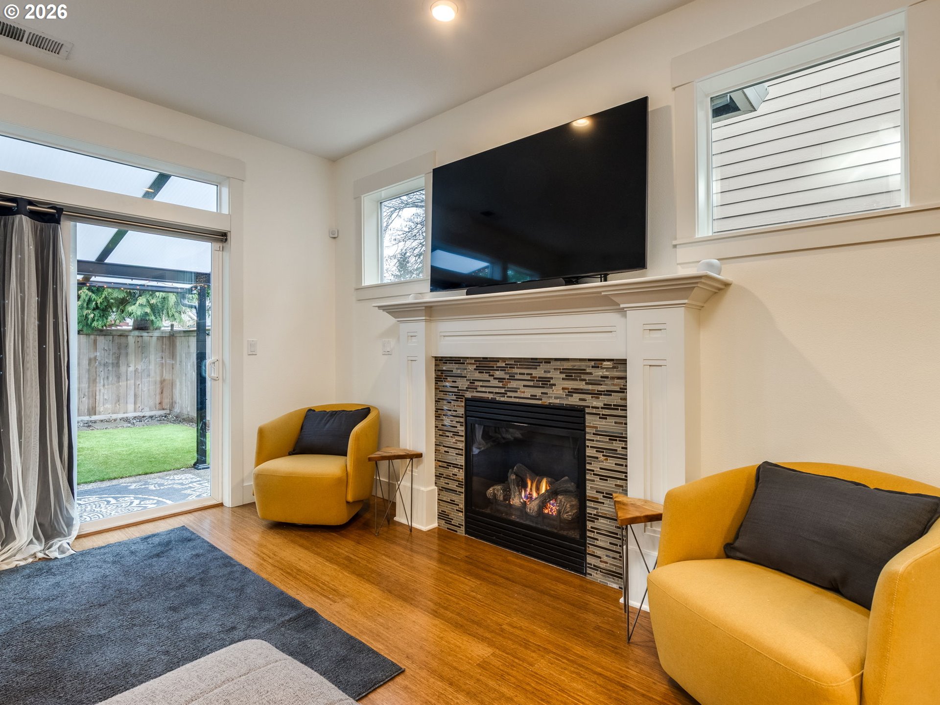 5619 Southeast Carlton Street Portland, OR 97206 - Photo 9 of 30 a living room with furniture a flat screen tv and a fireplace