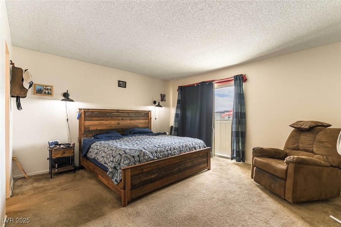 555 Rene Lane Henderson, NV 89015 - Photo 16 of 28 Primary Bedroom with baseboards, access to outside, light colored carpet, and a textured ceiling
balcony