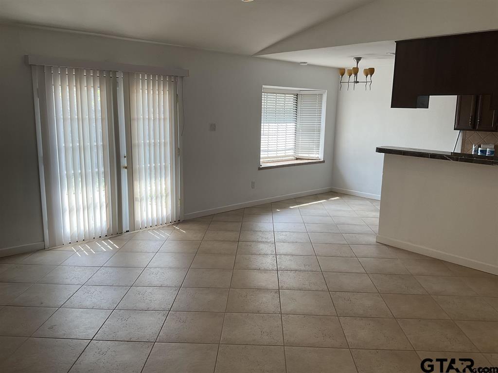 5101 Foxglove Circle Tyler, TX 75703 - Photo 3 of 12 a view of a kitchen and an empty room with a window
