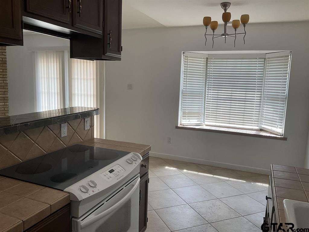5101 Foxglove Circle Tyler, TX 75703 - Photo 6 of 12 a kitchen with a stove and a sink
