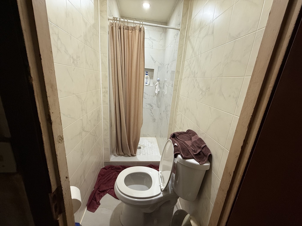 73-75 Draper Avenue Mansfield, MA 02048 - Photo 11 of 21 a bathroom with a sink and toilet